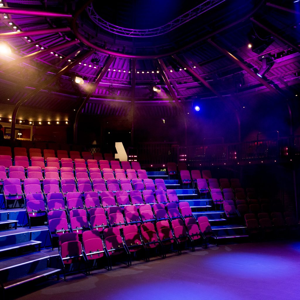 Part of the stage and seats in a theatre audiotorium.