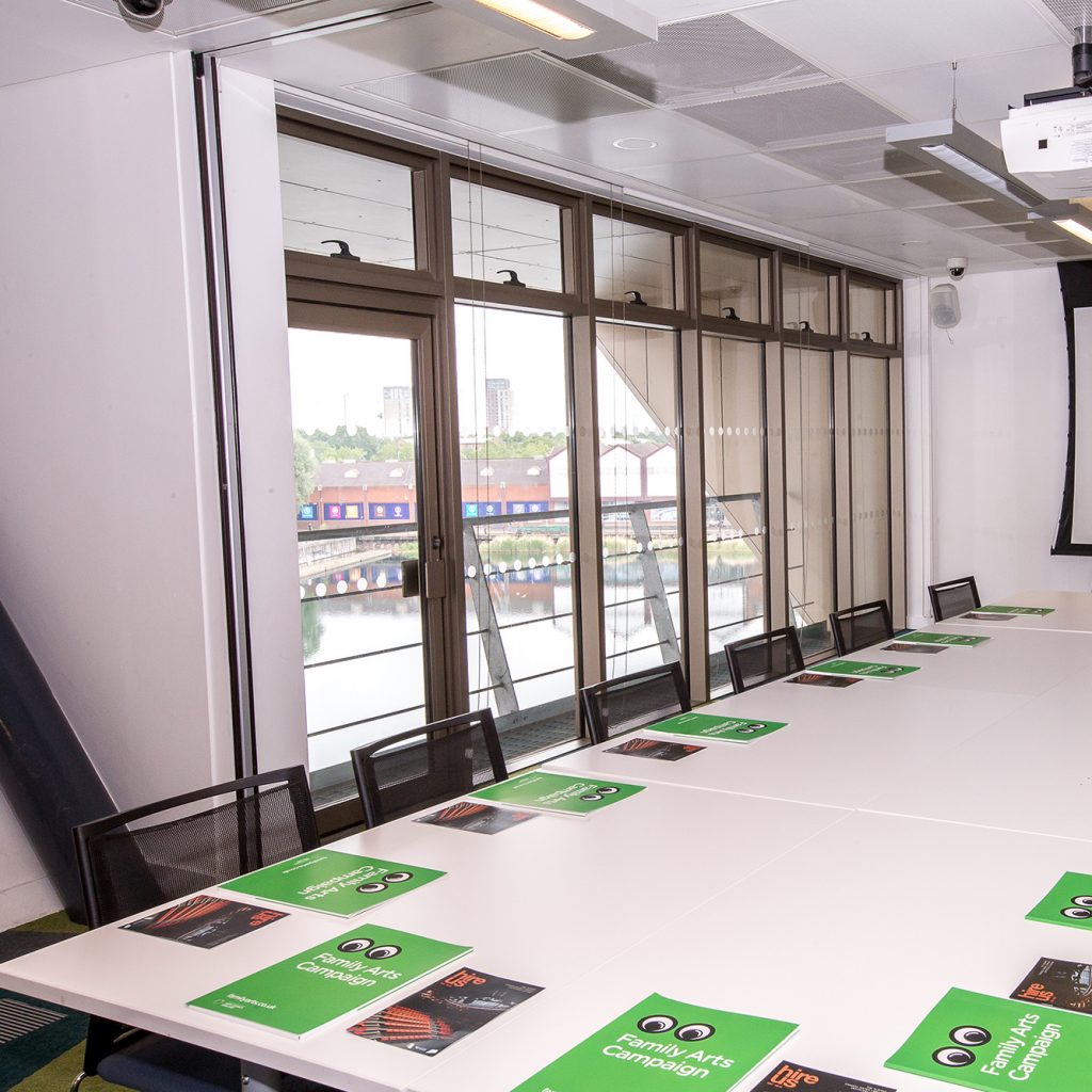Meeting room at Canada Water library with large windows and large Boardroom style table.
