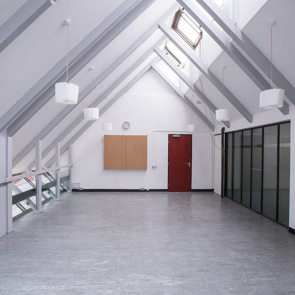 Rehearsal room with arched ceiling.