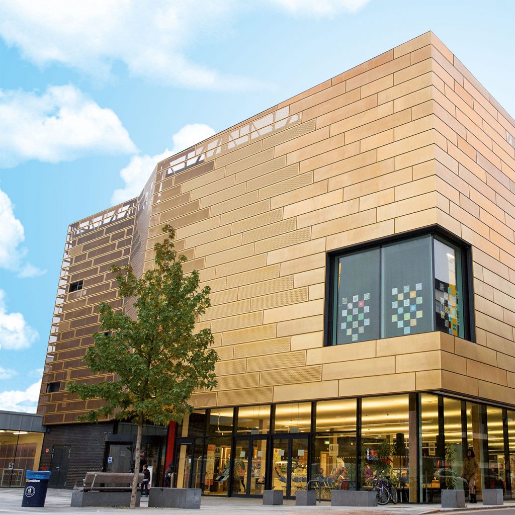 Large, modern looking, gold library building.