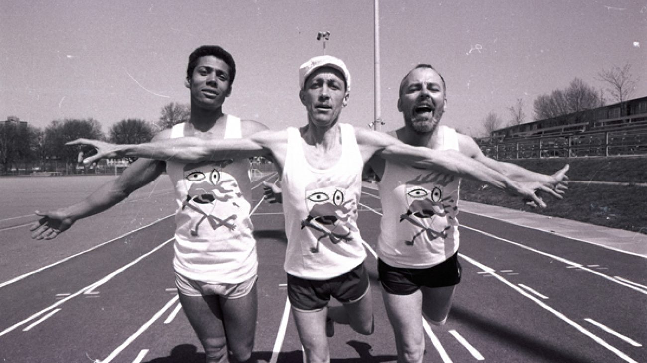 Three male actors posing on a race track, for a production called Marathon, 1984. 