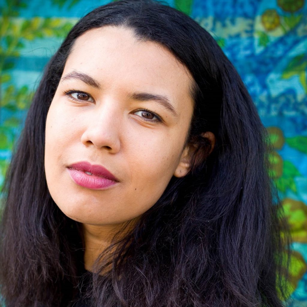 Photo of a young woman with dark hair and brown eyes.