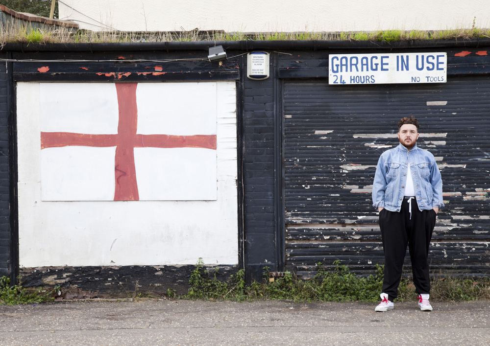 Scottee next to a St George's Flag