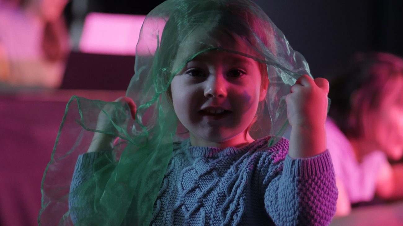 A young audience member enjoying Over The Moon.