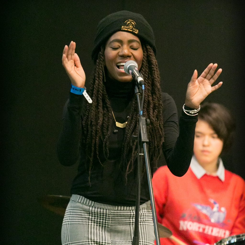 Image of girl singing into a microphone