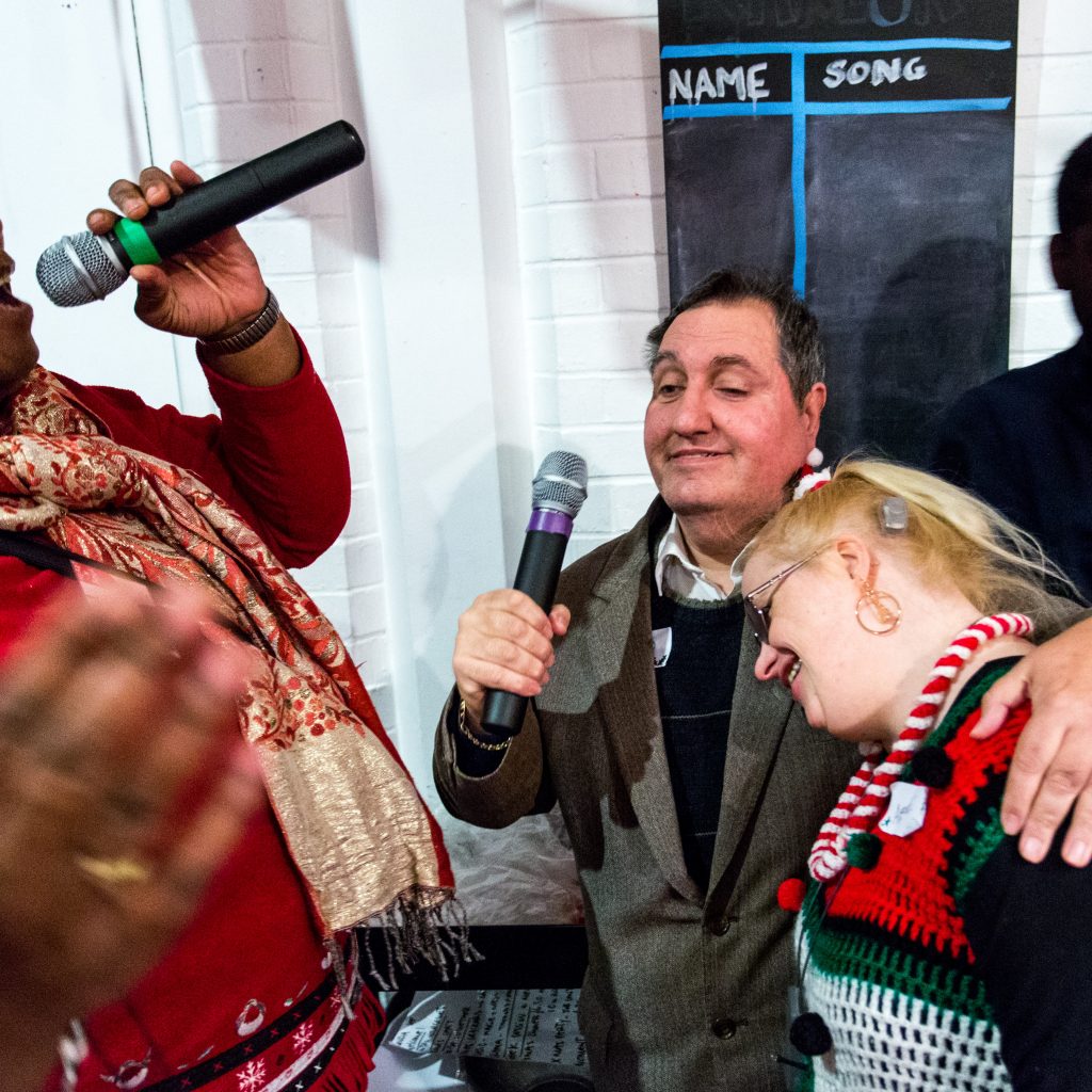 a group of people with mics sing together