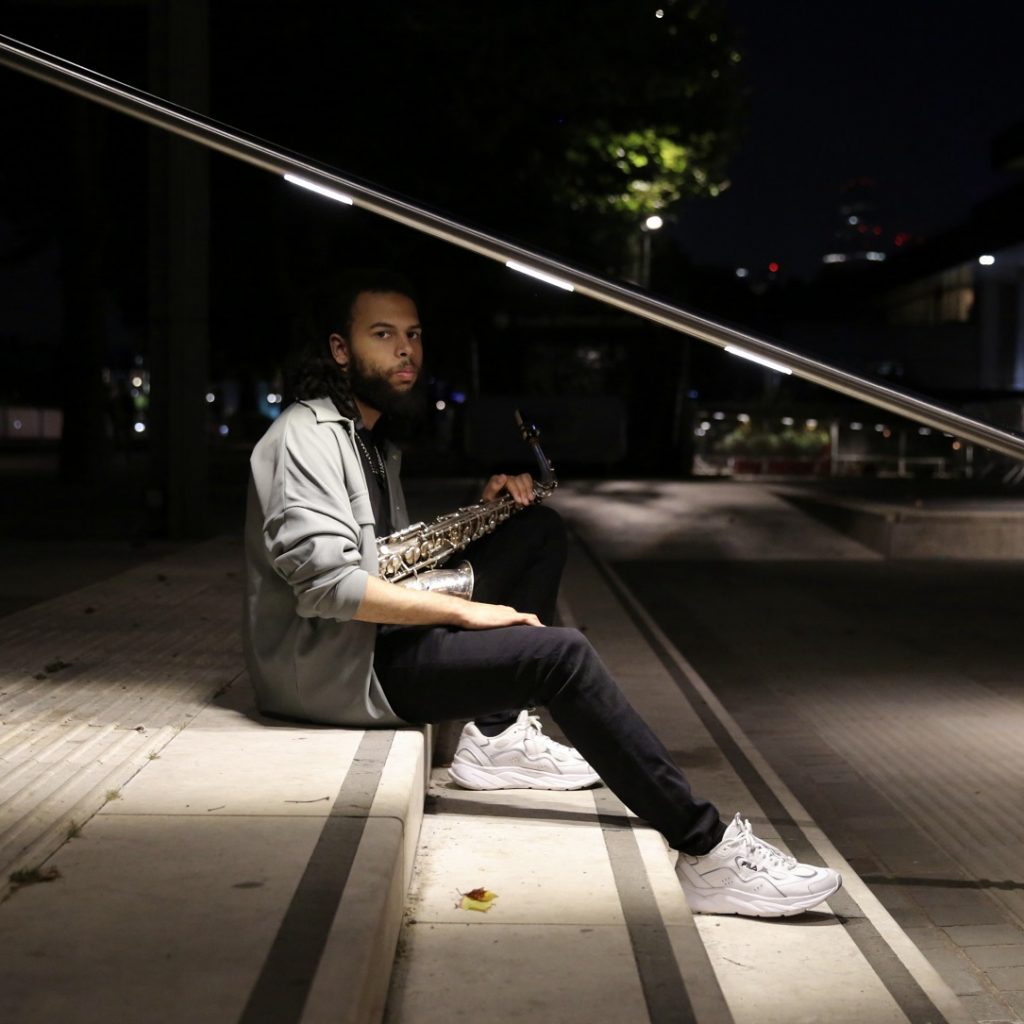 Image of a young man sitting on small steps.