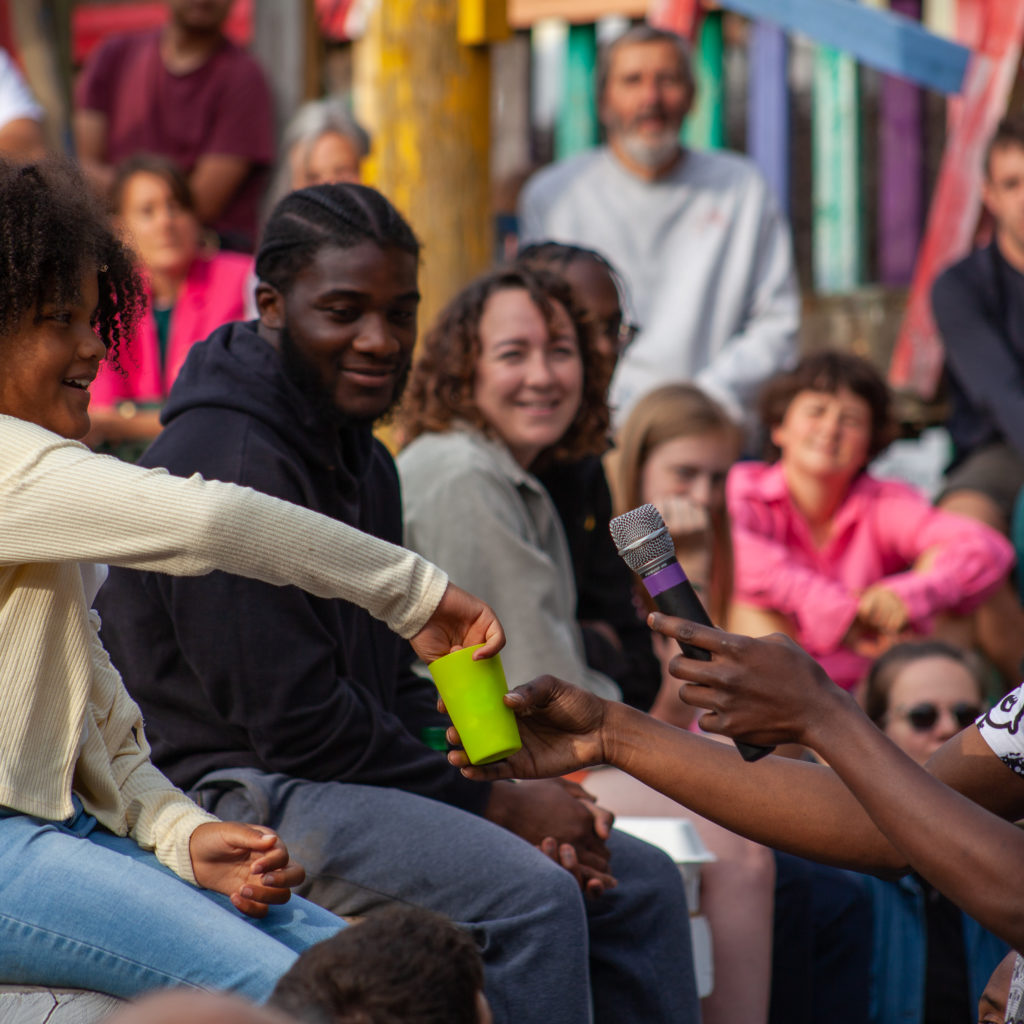 A girl is pulling something out of a container, part of the Climate Home Launch