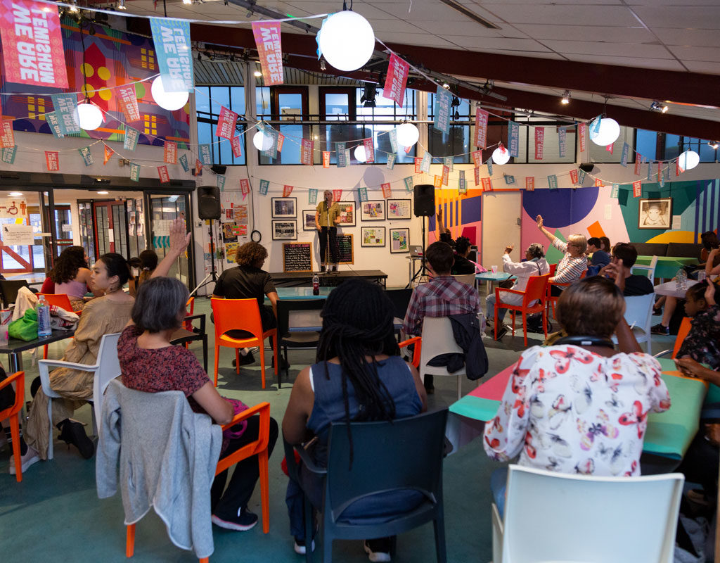 People at the Albany cafe facing a miniature stage for the 'Pizza & Pitches' event.